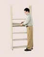 2. Lay a shelf over the bottom shelf supports. Then, moving upward, continue to add supports and shelves at each level.